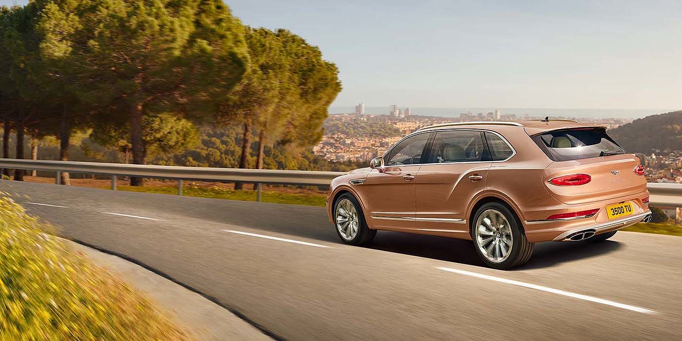 Exclusive Cars Vertriebs GmbH Bentley Bentayga EWB Azure SUV in Rose Gold paint rear 34