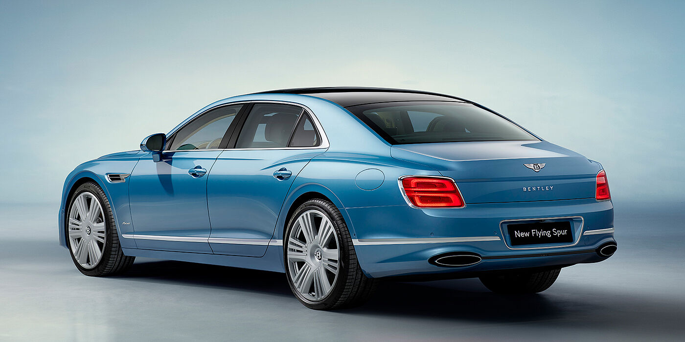 Exclusive Cars Vertriebs GmbH New Bentley Flying Spur Azure sedan rear view in Light windsor blue by Mulliner paint with 22 inch Azure wheels and chrome exterior details