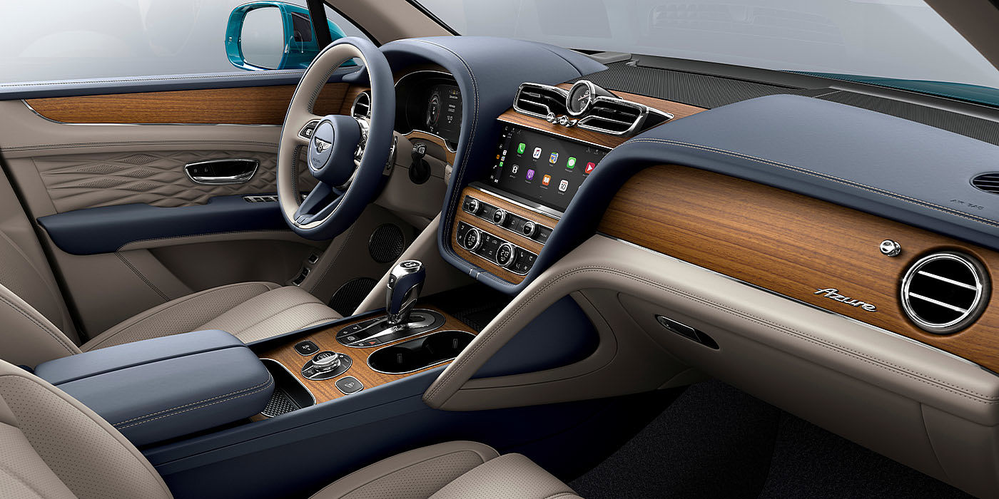 Exclusive Cars Vertriebs GmbH Bentley Bentayga EWB Azure interior with Open Pore Koa veneer, view from the passenger seat over looking the driver's seat. 