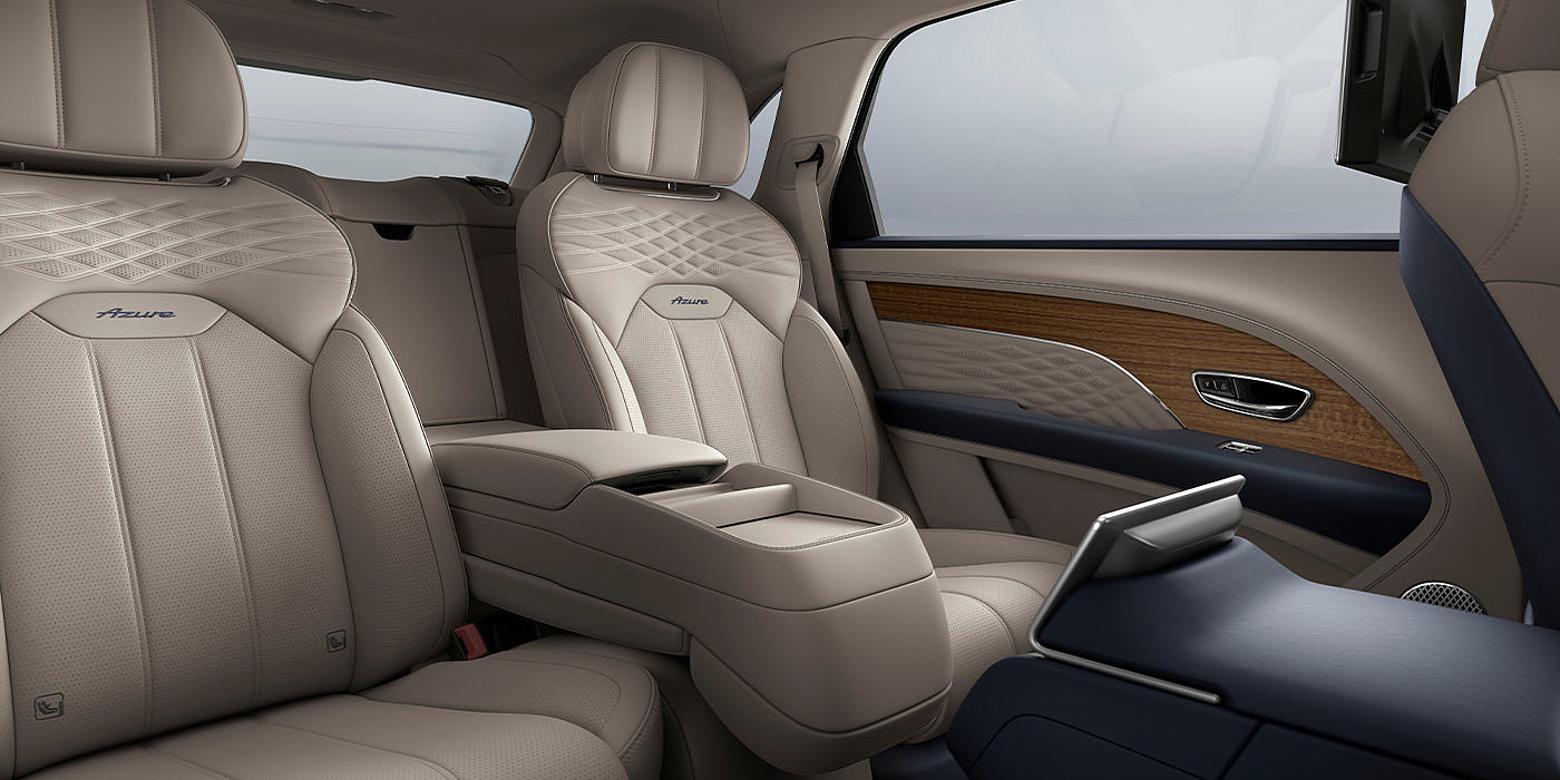 Exclusive Cars Vertriebs GmbH Bentley Bentayga EWB Azure interior view for rear passengers with Portland hide featuring Azure Emblem in Imperial Blue contrast stitch.