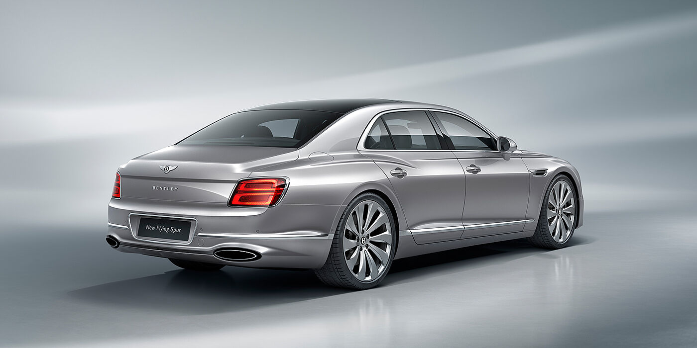 Exclusive Cars Vertriebs GmbH New Bentley Flying Spur sedan rear view in Silverlake paint with ten spoke wheels and chrome matrix grille