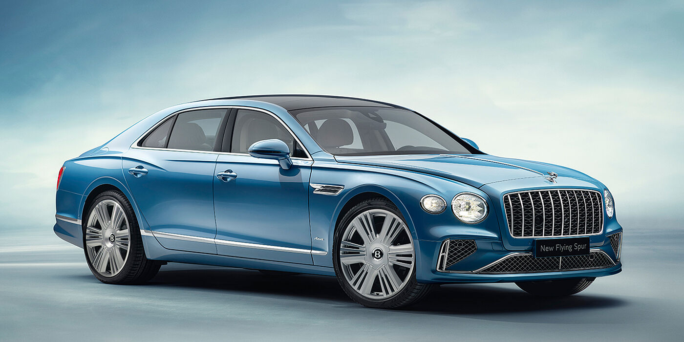 Exclusive Cars Vertriebs GmbH New Bentley Flying Spur Azure sedan front view in Light windsor blue by Mulliner paint with 22 inch Azure wheels and chrome exterior details
