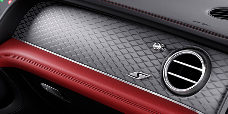 Exclusive Cars Vertriebs GmbH Bentley Bentayga S SUV front interior dash with Dark Tint Diamond Brushed Aluminium veneer and S badge surrounded by Hotspur red and Beluga black hide