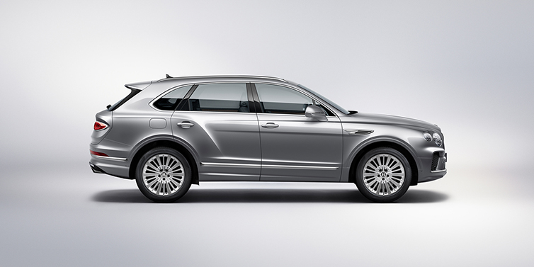 Exclusive Cars Vertriebs GmbH Bentley Bentayga SUV side profile in Moonbeam silver paint against white background featuring 21 inch 5 spoke wheels