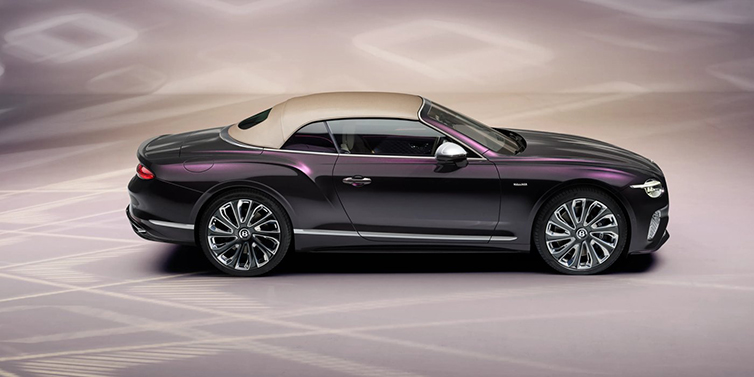 Exclusive Cars Vertriebs GmbH Bentley Continental GTC Mulliner convertible in profile with hood up, in Tanzanite Purple paint and 22 inch Mulliner painted and polished wheels