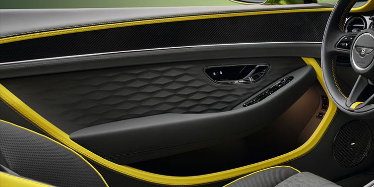 Exclusive Cars Vertriebs GmbH Bentley Continental GTC Speed convertible interior door details featuring Gravity Grey and Cyber Yellow by Mulliner hides and high gloss carbon fibre veneer