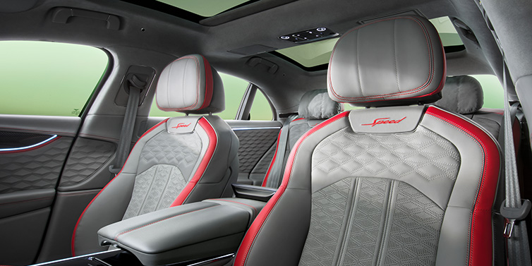 Exclusive Cars Vertriebs GmbH Bentley Flying Spur Speed sedan interior showing front and rear seats in Hotspur red and Gravity Grey hides, with Speed seat emblems