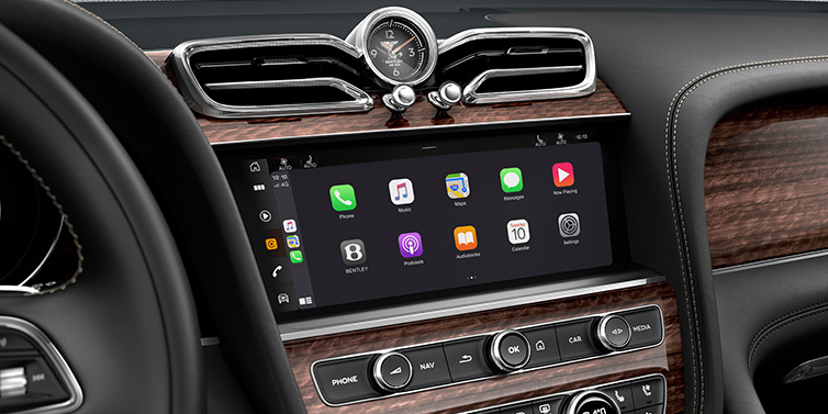 Exclusive Cars Vertriebs GmbH Bentley Bentayga Extended Wheelbase SUV front interior centre console MMI screen showing apps surrounded by Beluga black hide and Crown Cut Walnut veneer