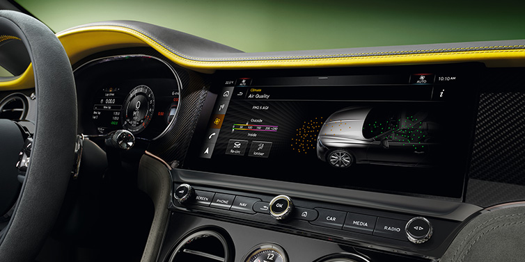 Exclusive Cars Vertriebs GmbH Bentley Continental GTC Speed convertible front interior centre console with MMI screen showing Air Quality visualisation surrounded by Cyber Yellow by Mulliner and Gravity Grey hides and high gloss carbon fibre veneer